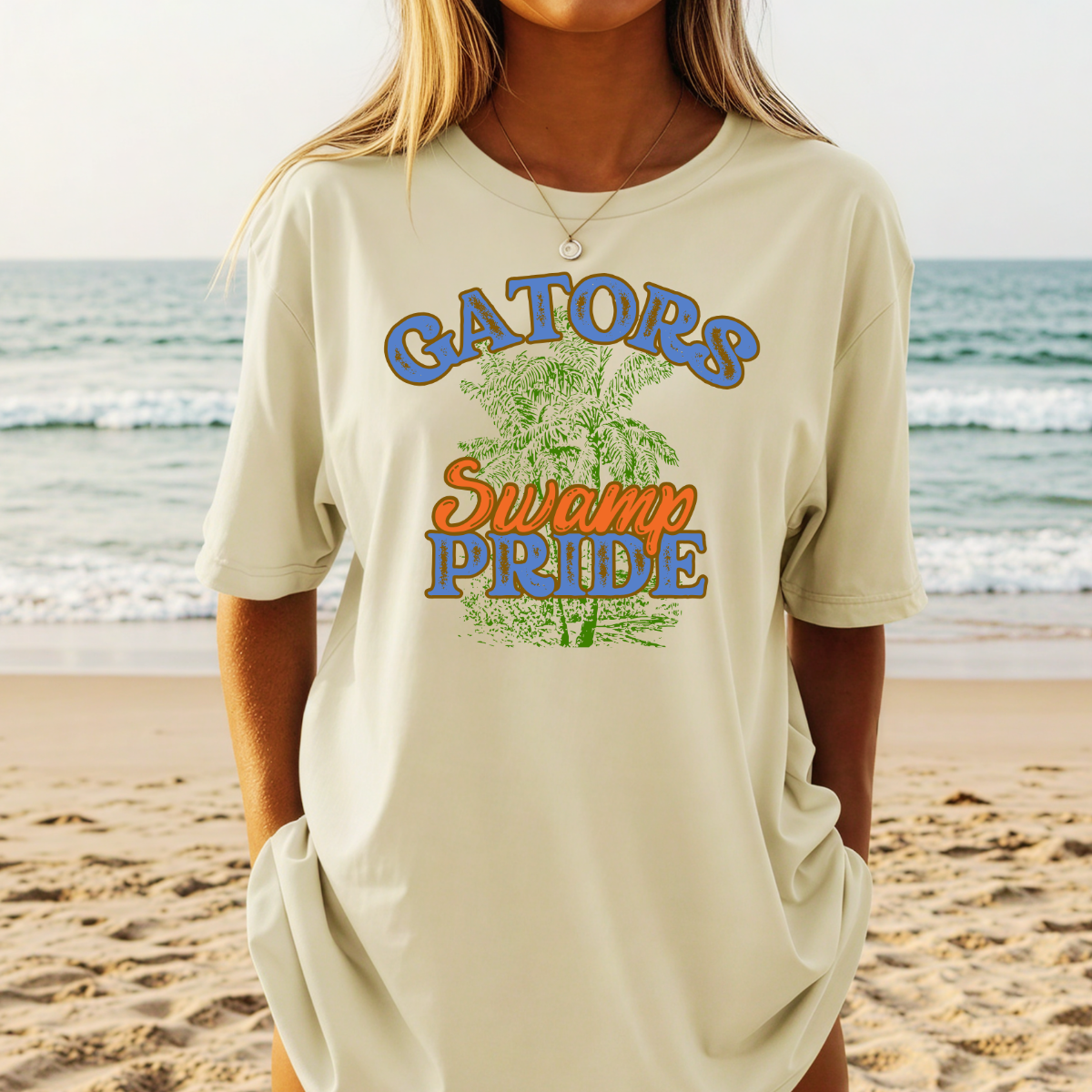 Person wearing a 'Gators Swamp Pride' t-shirt on a beach